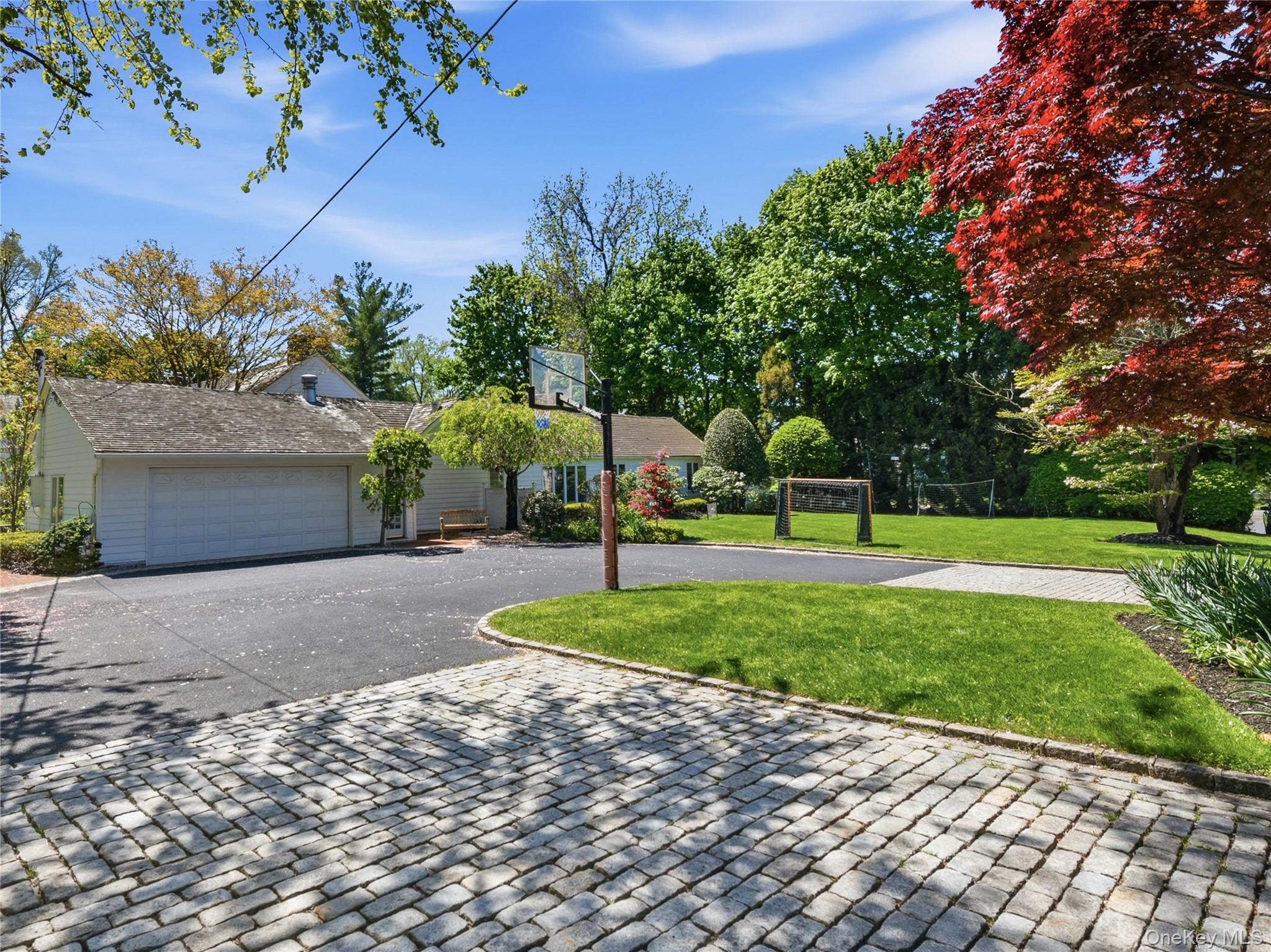2 Aspen Place Great Neck, NY 11021 - Photo 41 of 48 Side elevation with circular paver driveway & attached 2 car garage