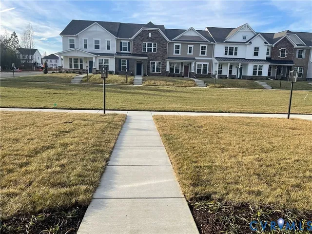 a view of residential houses with outdoor space and lake view