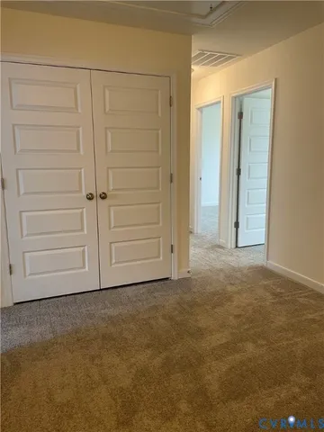 an empty room with closet area