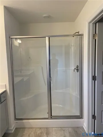 a bathroom with a glass shower door