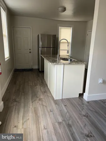 a view of a hardwood & utility room with wooden floor