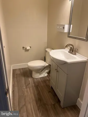 a bathroom with a sink toilet and a mirror