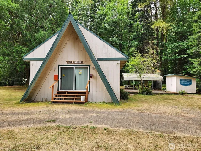a backyard of a house with barbeque oven table and chairs