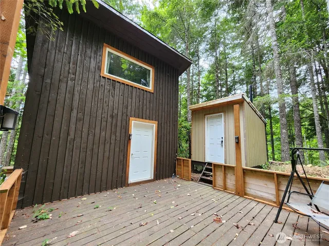 a view of backyard with a deck and wooden floor