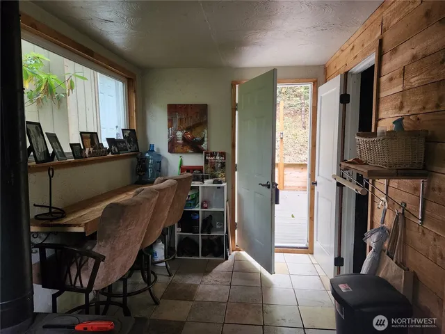 a room with furniture a flat screen tv and a window