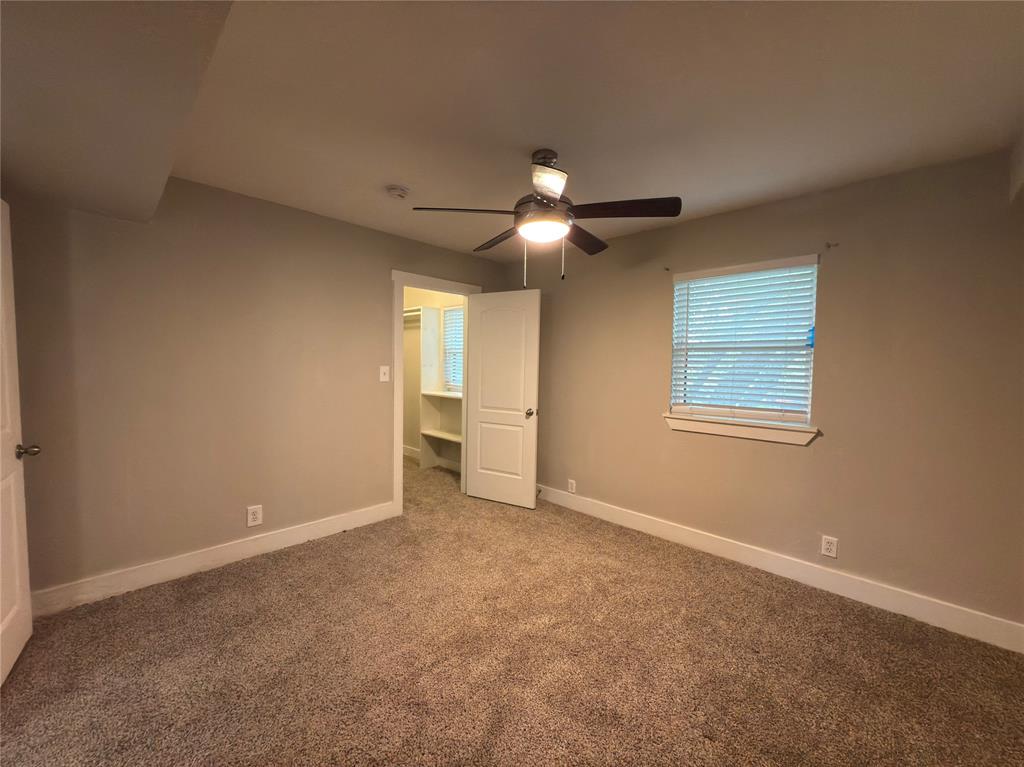 5928 Fletcher Avenue, Unit 16 Fort Worth, TX 76107 - Photo 12 of 20 an empty room with windows and fan