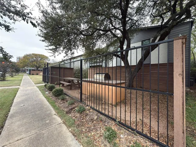 a view of house with backyard and trees