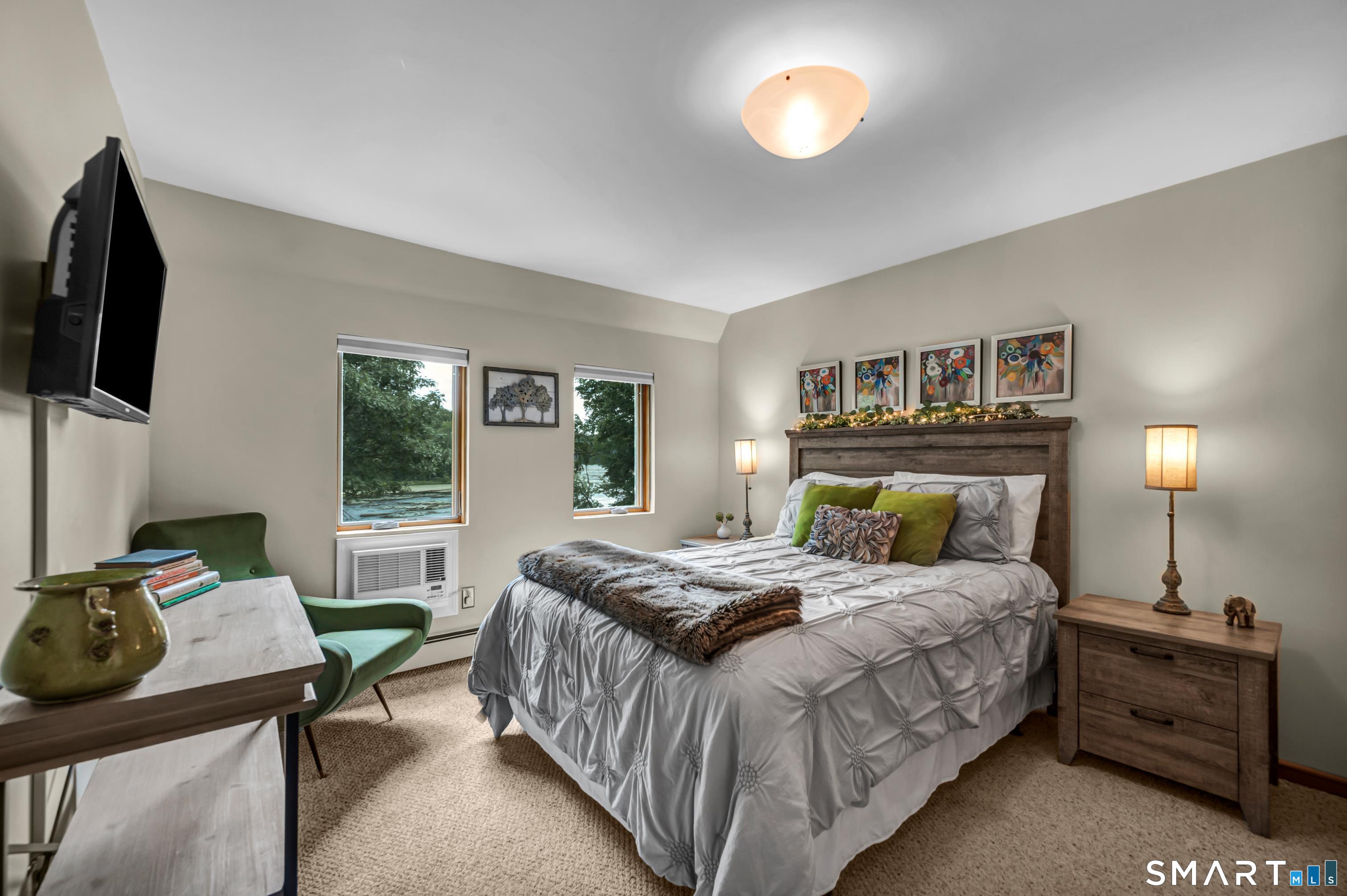 106 Hunt Road Columbia, CT 06237 - Photo 35 of 40 a bedroom with a bed and flat screen tv