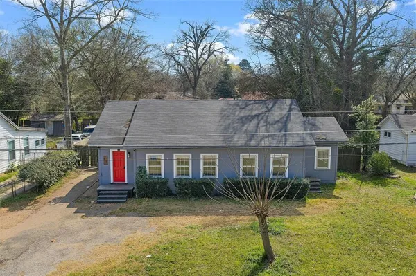 a house that has a tree in front of it