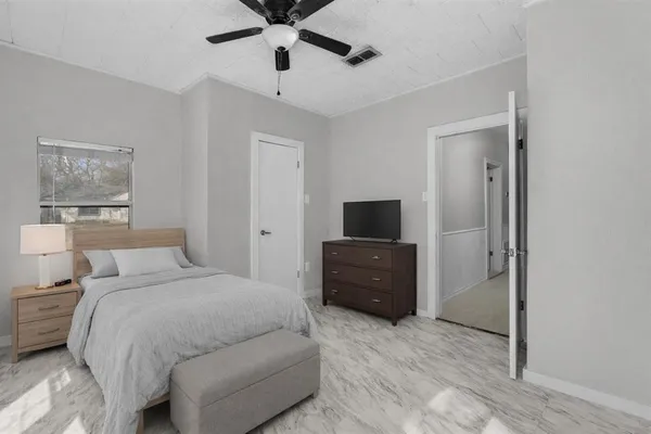 a bedroom with a bed and a television