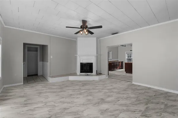 a view of an empty room with a fireplace