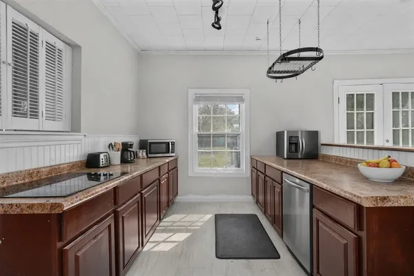 a kitchen with a sink stove and cabinets