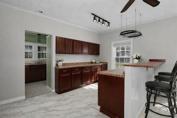 a kitchen with stainless steel appliances granite countertop a refrigerator a stove top oven a sink dishwasher and wooden cabinets