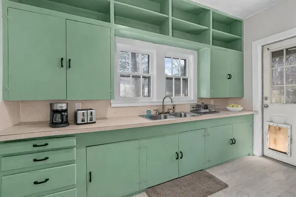 a bathroom with a double vanity sink and a mirror