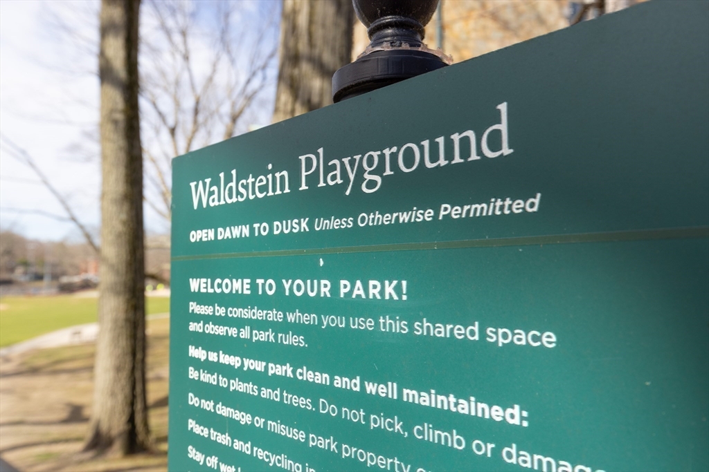 24 Dean Road, Unit 3 Brookline, MA 02445 - Photo 2 of 3 a sign on the side of a building