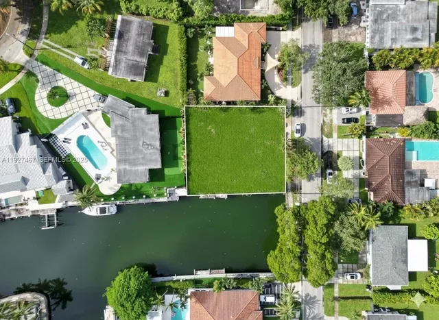 an aerial view of a house with a lake