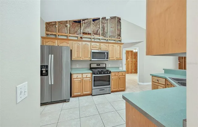a kitchen with stainless steel appliances granite countertop a stove and a refrigerator