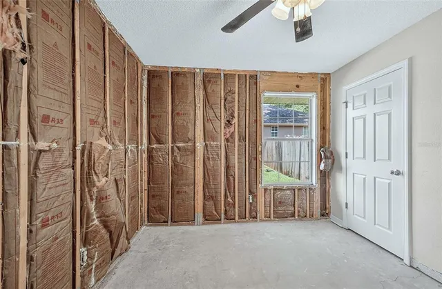 a view of a hallway with a chandelier fan