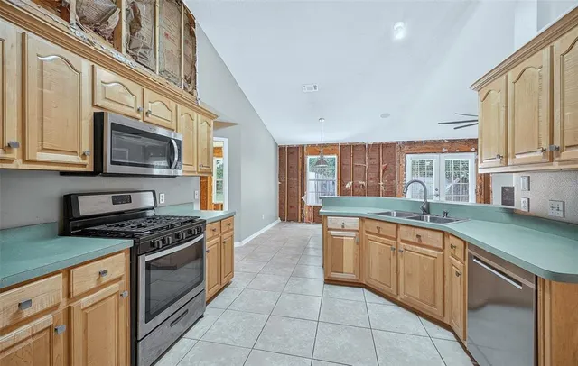 a kitchen with stainless steel appliances granite countertop a sink and stove top oven