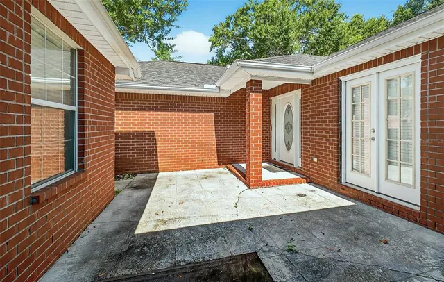 a view of a backyard with table and chairs and wooden fence