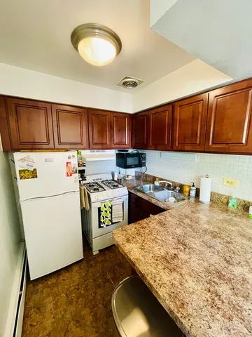 a kitchen with a stove a sink and a refrigerator