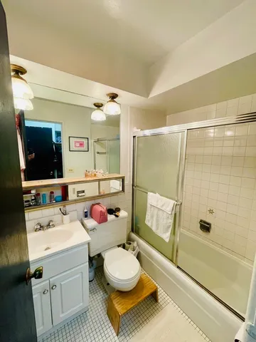 a bathroom with a sink mirror vanity and toilet