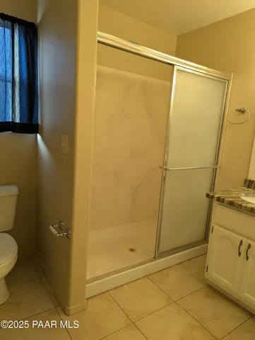 a view of wooden floor and chandelier fan