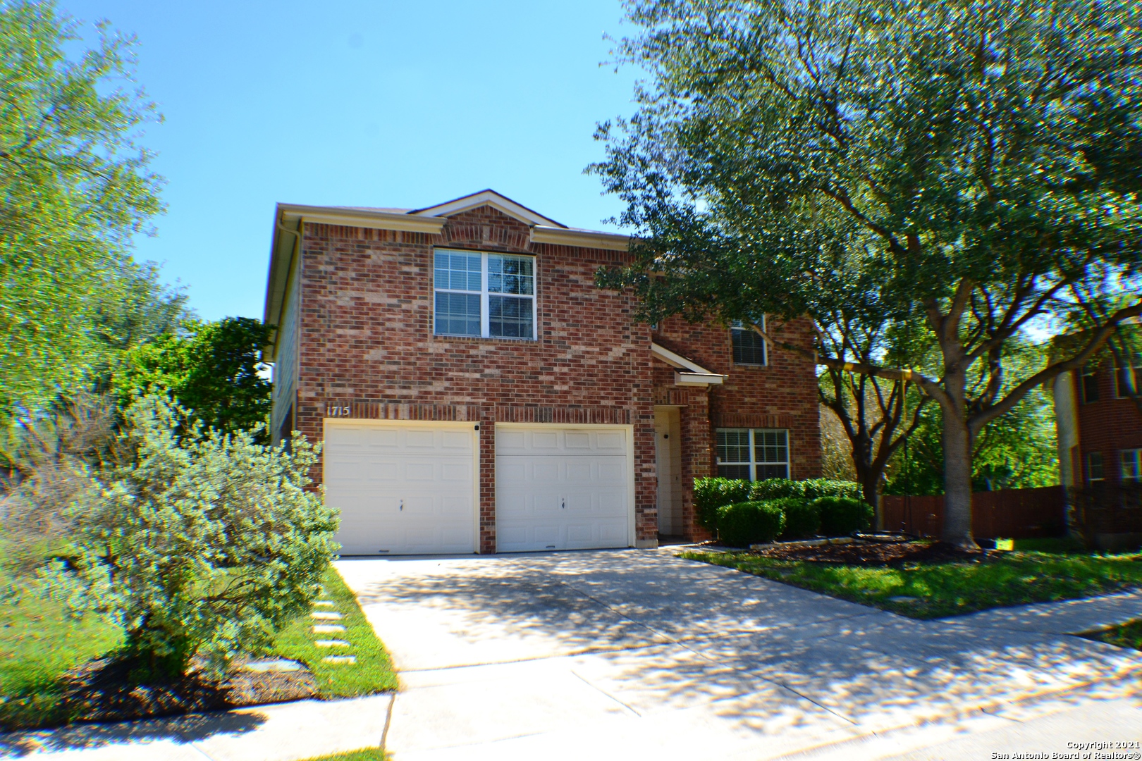 1715 Mountain Brook Schertz, TX 78154 - Photo 1 of 44 a front view of a house with garden