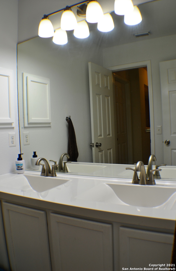 1715 Mountain Brook Schertz, TX 78154 - Photo 24 of 44 a bathroom with a sink and a mirror