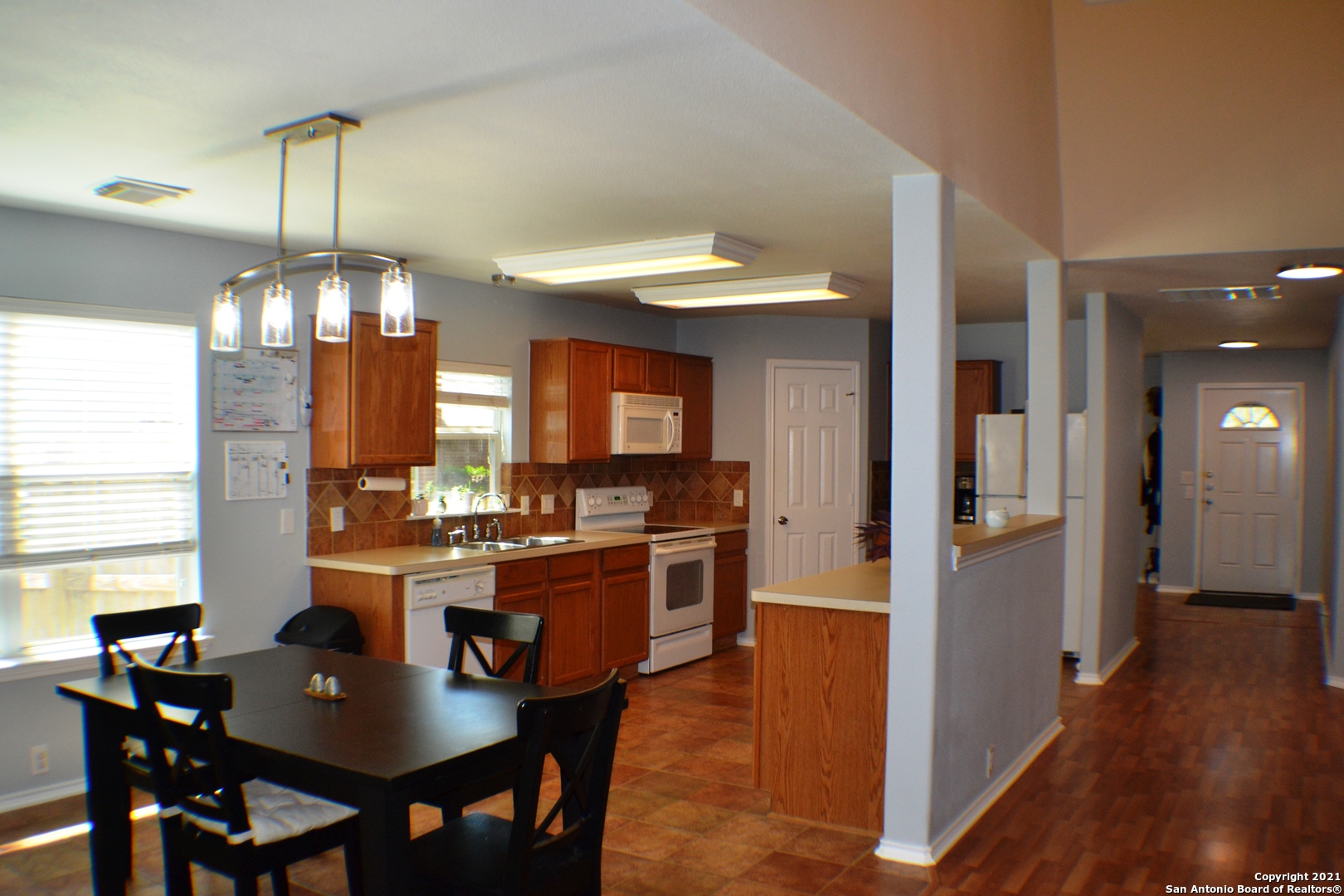 1715 Mountain Brook Schertz, TX 78154 - Photo 3 of 44 a dining room with furniture a chandelier and wooden floor