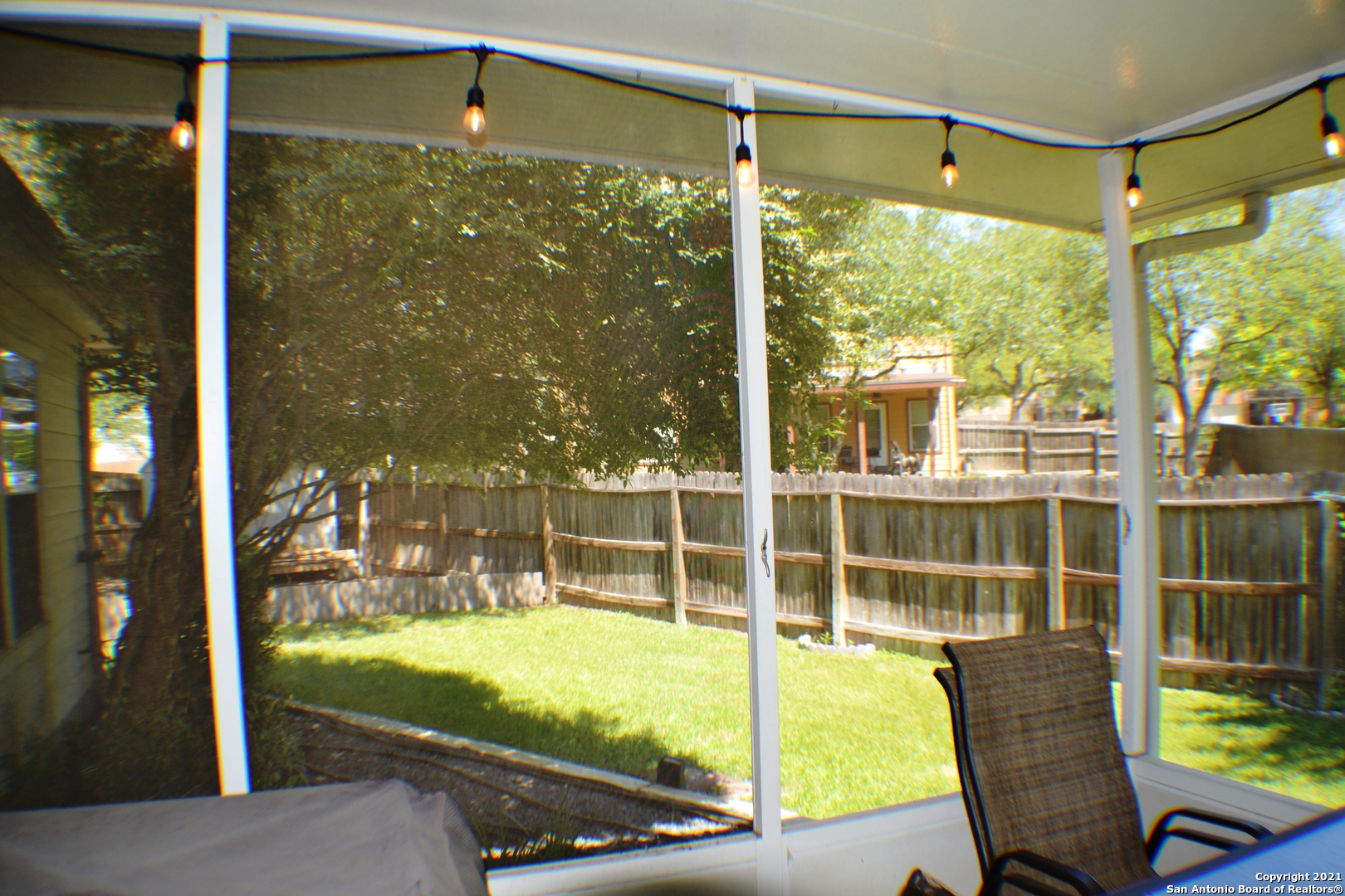 1715 Mountain Brook Schertz, TX 78154 - Photo 36 of 44 a view of a glass door with a floor to ceiling window and chair