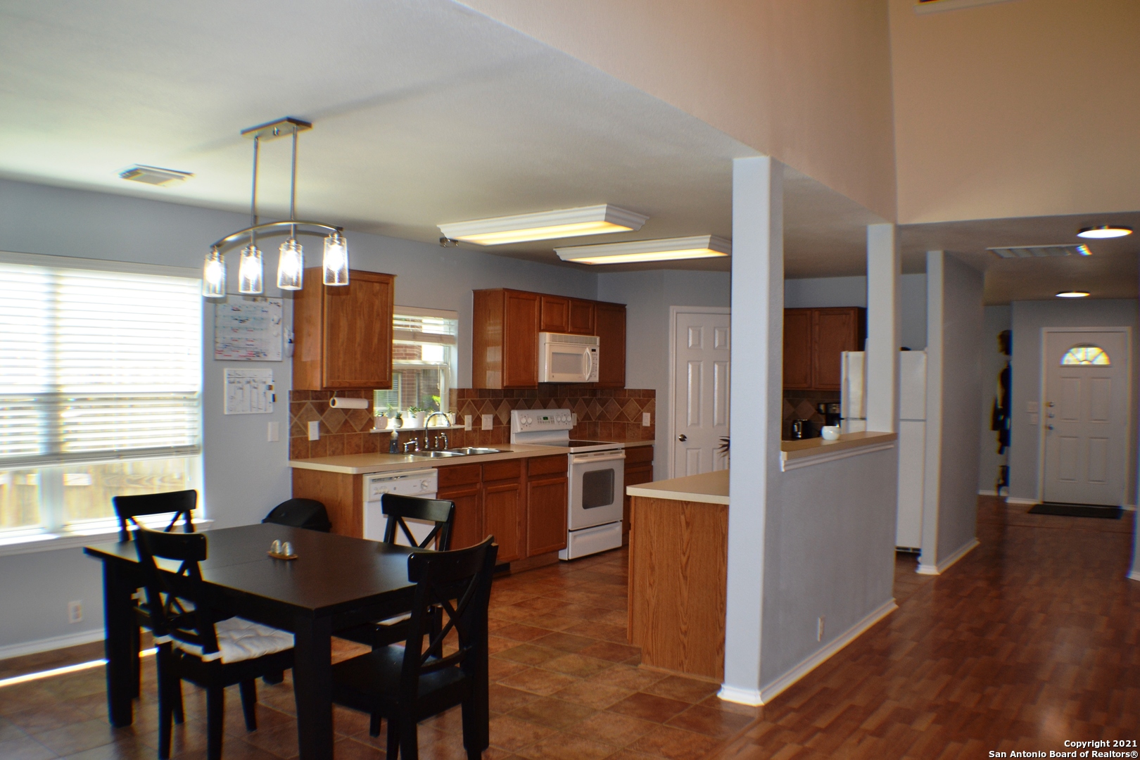 1715 Mountain Brook Schertz, TX 78154 - Photo 9 of 44 a view of a dining room with furniture window and wooden floor