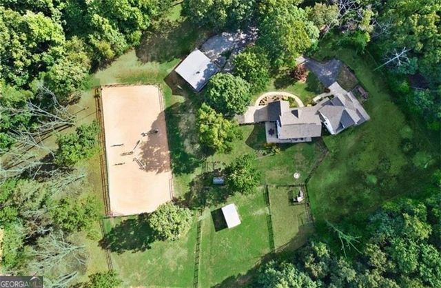 a backyard of a house with lots of green space and fountain