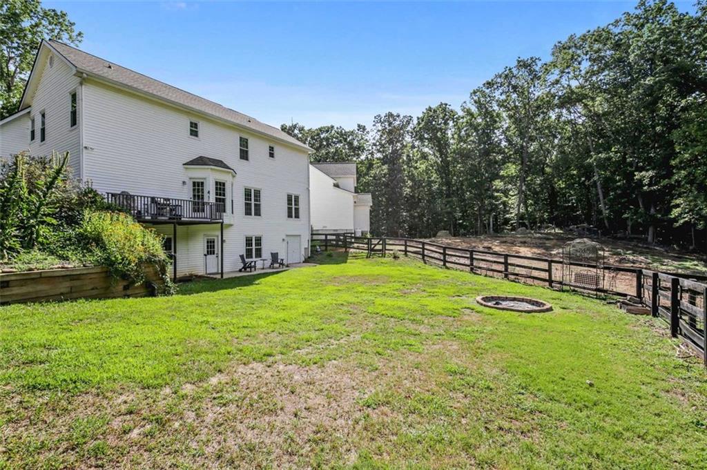 2203 Arbor Hill Road Canton, GA 30115 - Photo 28 of 64 a view of a house with swimming pool and a yard