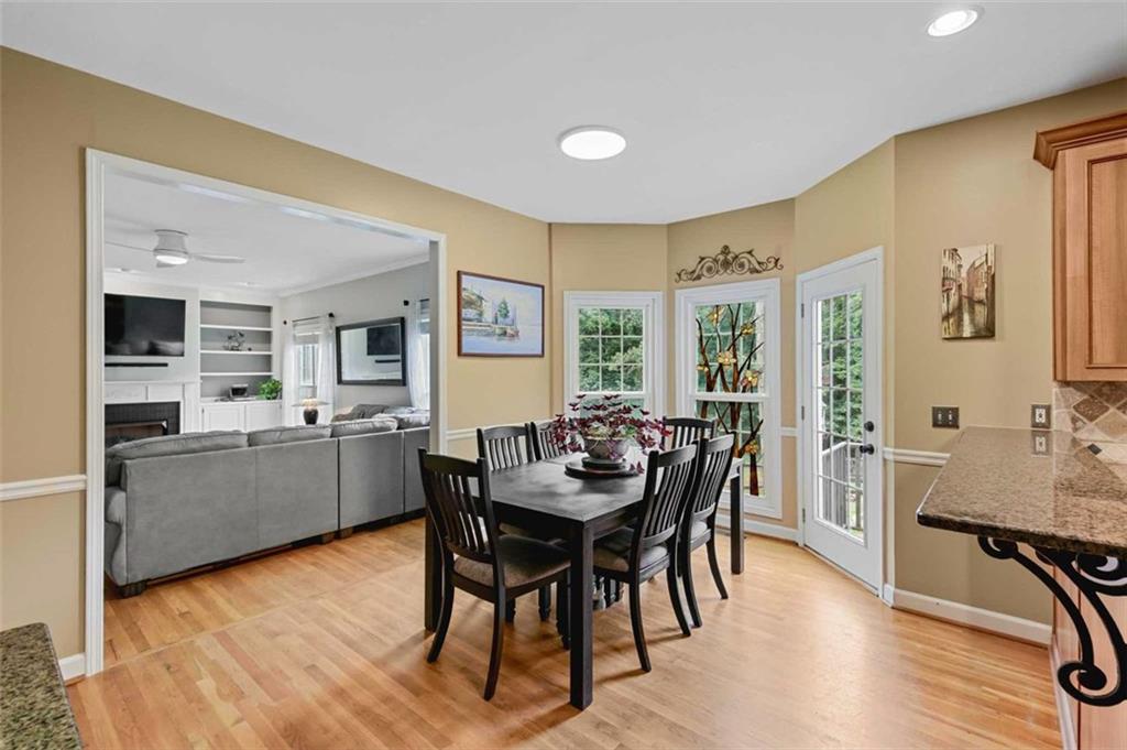 2203 Arbor Hill Road Canton, GA 30115 - Photo 36 of 64 a view of a dining room with furniture and wooden floor