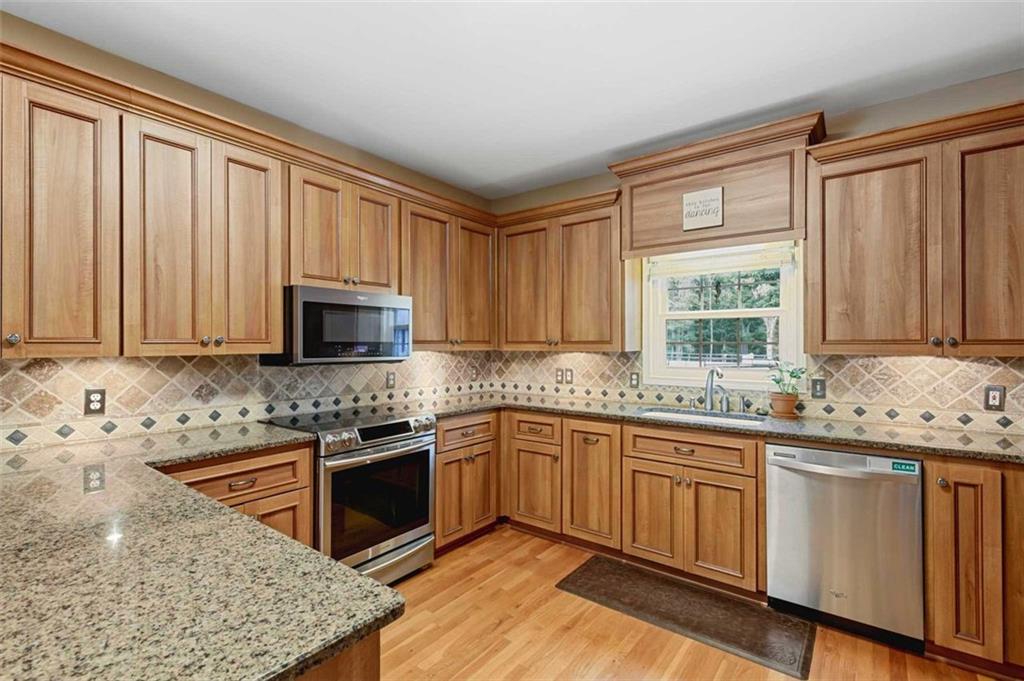 2203 Arbor Hill Road Canton, GA 30115 - Photo 37 of 64 a kitchen with stainless steel appliances granite countertop a stove a sink and a microwave