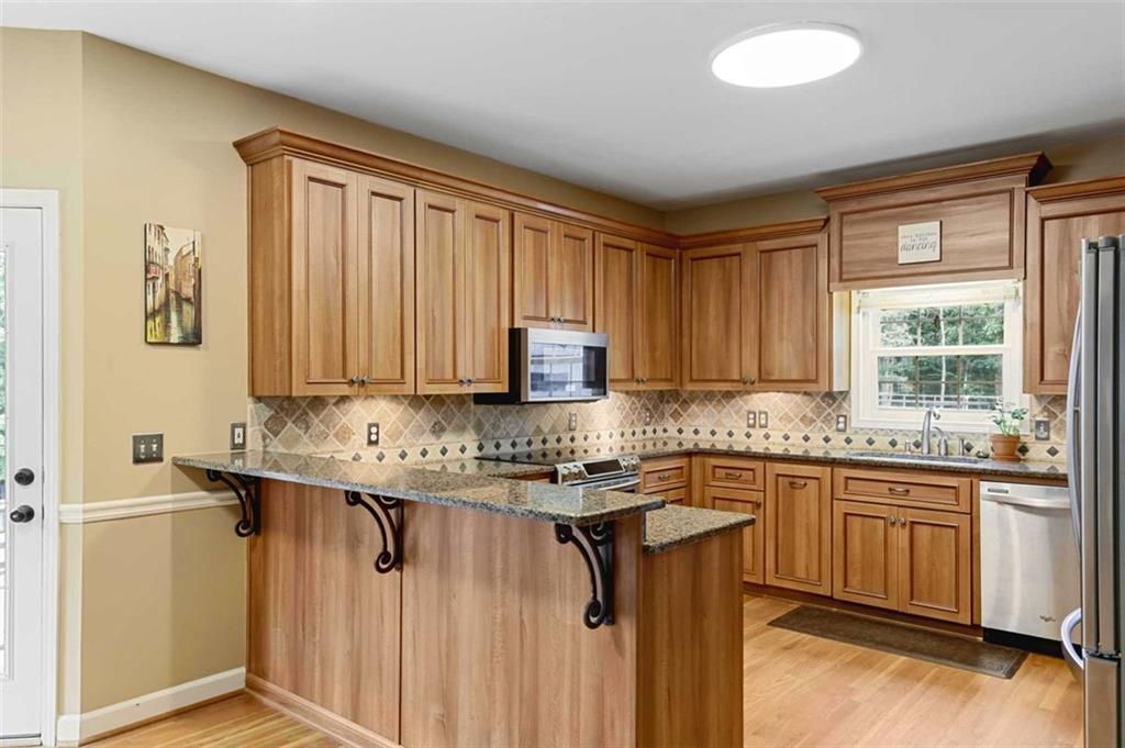 2203 Arbor Hill Road Canton, GA 30115 - Photo 38 of 64 a kitchen with a sink stove and cabinets