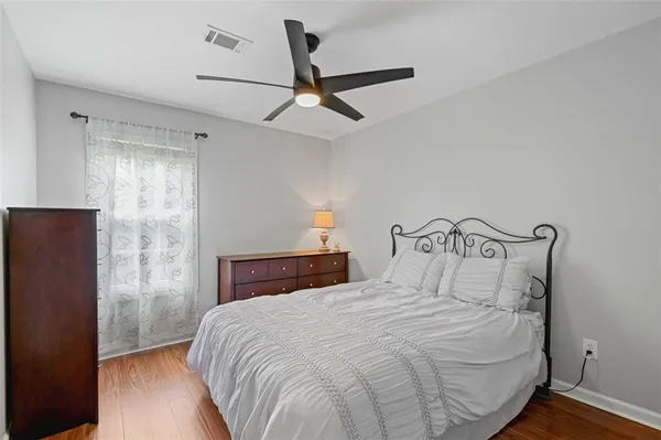 a spacious bathroom with a double vanity sink a large mirror and a toilet