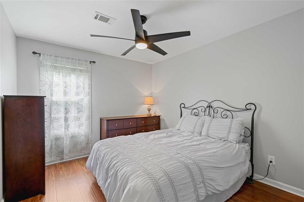 2203 Arbor Hill Road Canton, GA 30115 - Photo 48 of 64 a bedroom with a bed and a ceiling fan