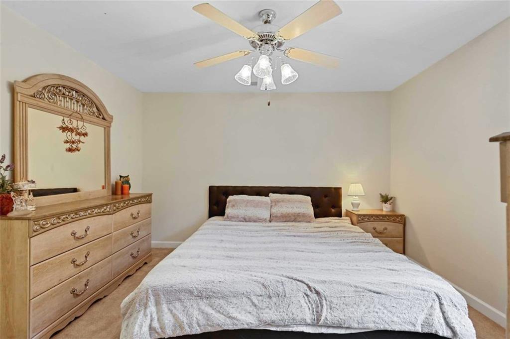 2203 Arbor Hill Road Canton, GA 30115 - Photo 62 of 64 a bedroom with a bed and a chandelier