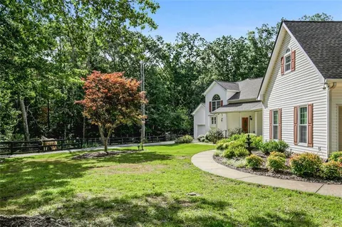 a view of a backyard with swimming pool