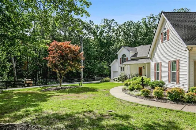 a view of a backyard with swimming pool