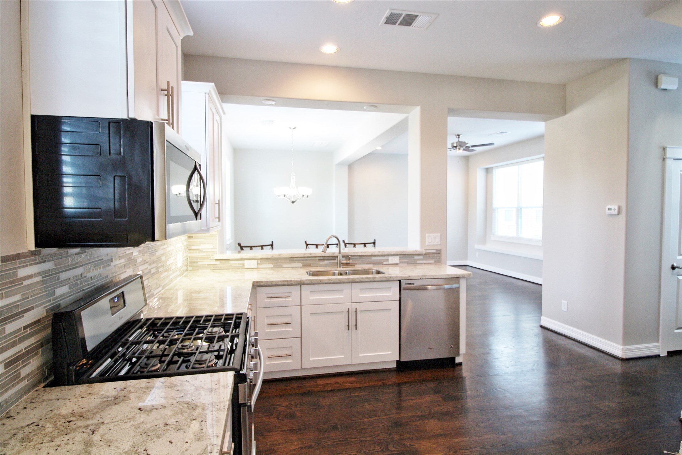 709 Link Road Houston, TX 77009 - Photo 8 of 46 a large kitchen with stainless steel appliances granite countertop a stove and a wooden cabinets