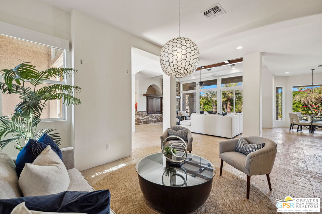 2 Varsity Circle Rancho Mirage, CA 92270 - Photo 12 of 65 a view of a livingroom and dining room with furniture wooden floor and a chandelier