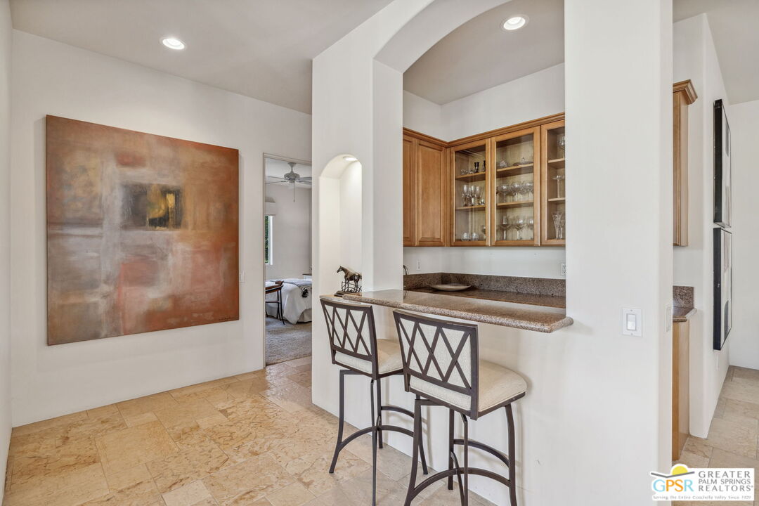 2 Varsity Circle Rancho Mirage, CA 92270 - Photo 13 of 65 a kitchen with stainless steel appliances granite countertop a stove a sink and a refrigerator with wooden floor