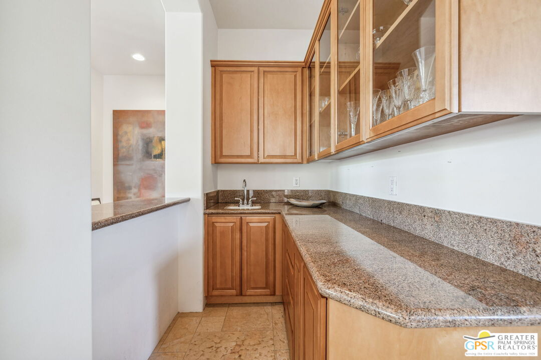 2 Varsity Circle Rancho Mirage, CA 92270 - Photo 14 of 65 a kitchen with granite countertop a sink and a stove