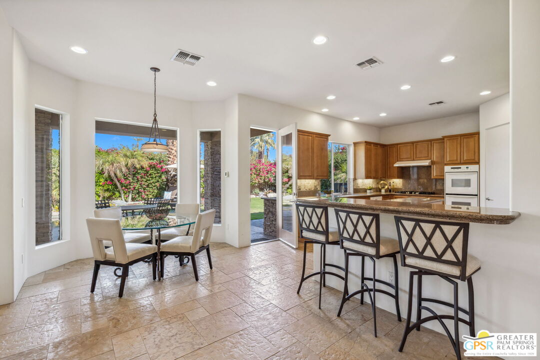 2 Varsity Circle Rancho Mirage, CA 92270 - Photo 15 of 65 a view of a dining room with furniture window and wooden floor