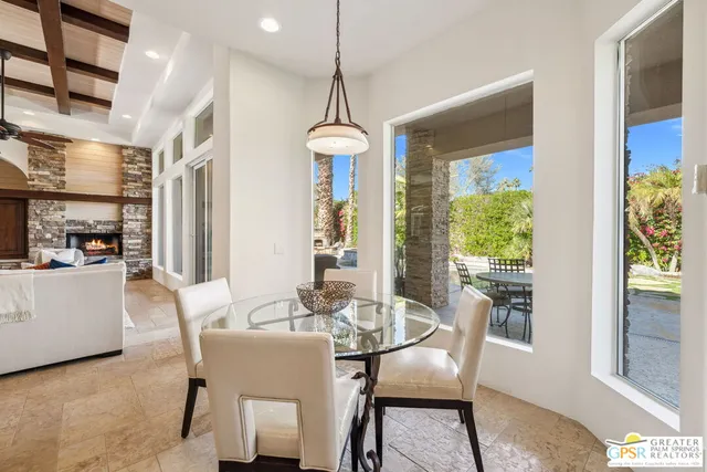 a view of an outdoor dining space with a table and chairs