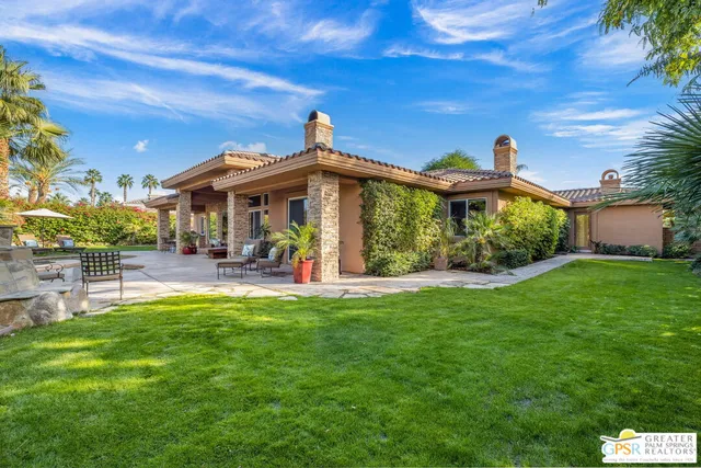 a view of a house with a backyard porch and sitting area