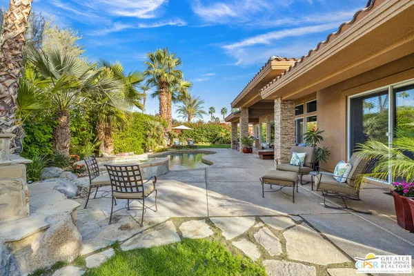a view of a patio with table and chairs and potted plants